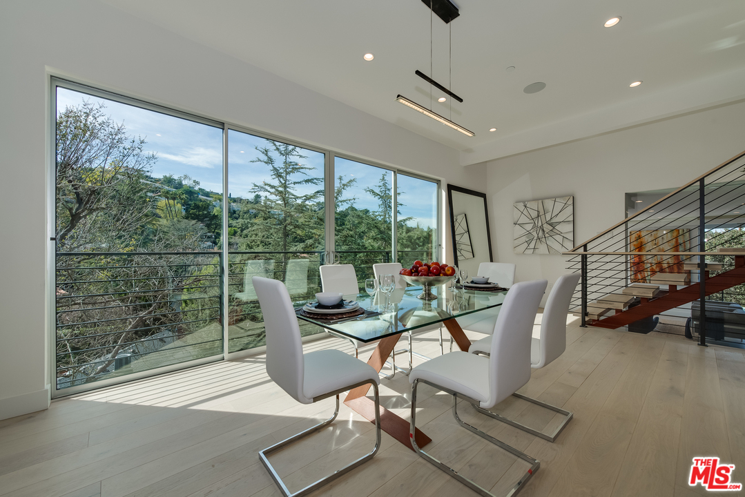 3431 Coy Drive Sherman Oaks, CA 91423 - Photo 15 of 54 a dining room with furniture water view and a floor to ceiling window