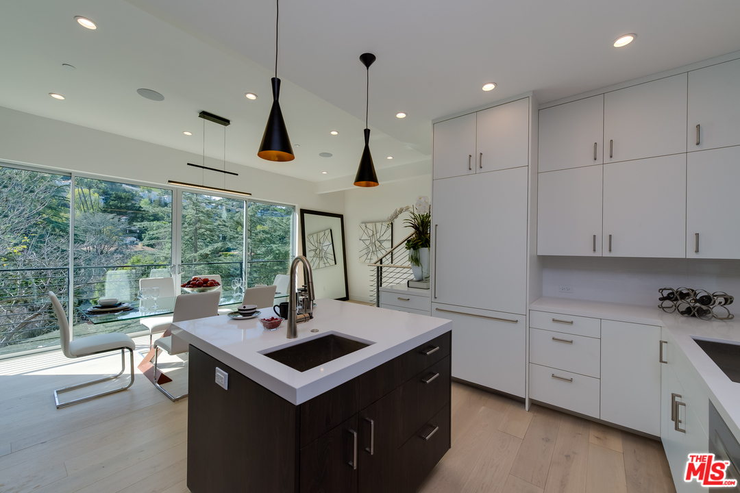 3431 Coy Drive Sherman Oaks, CA 91423 - Photo 18 of 54 a kitchen with a stove a sink a counter top space and living room view