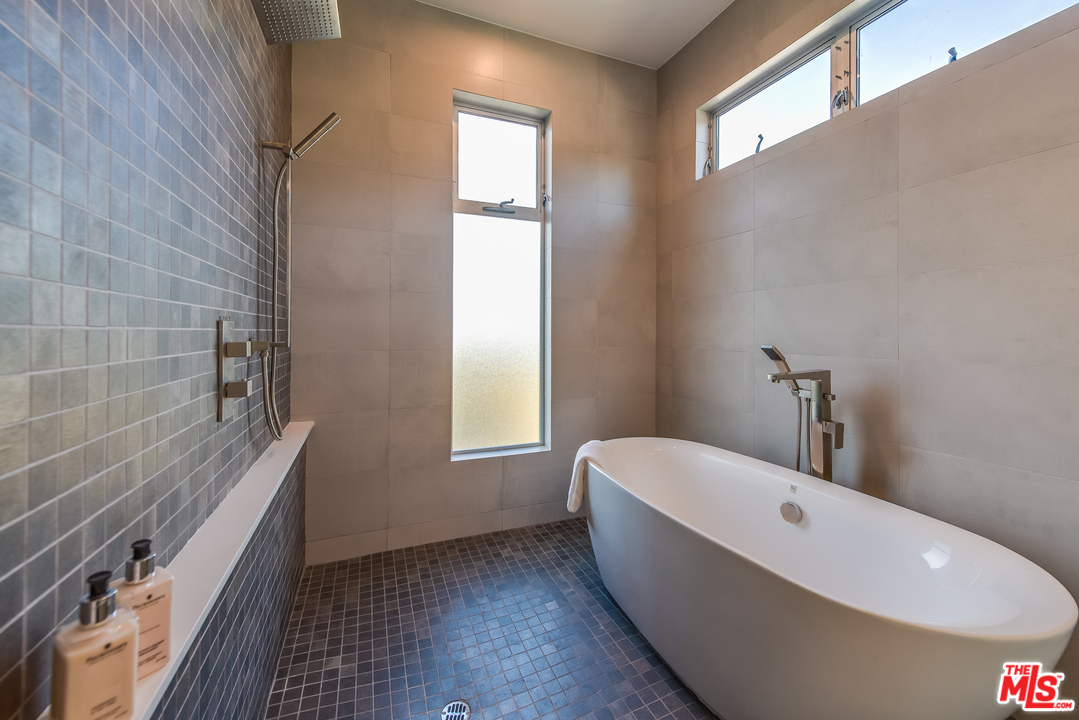 3431 Coy Drive Sherman Oaks, CA 91423 - Photo 25 of 54 a bathroom with a bathtub and window