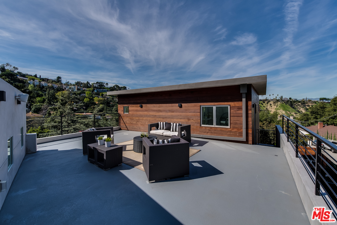 3431 Coy Drive Sherman Oaks, CA 91423 - Photo 26 of 54 a living room with furniture and a fireplace