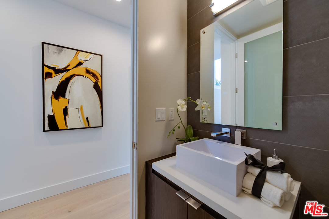 3431 Coy Drive Sherman Oaks, CA 91423 - Photo 29 of 54 a bathroom with a sink and a mirror