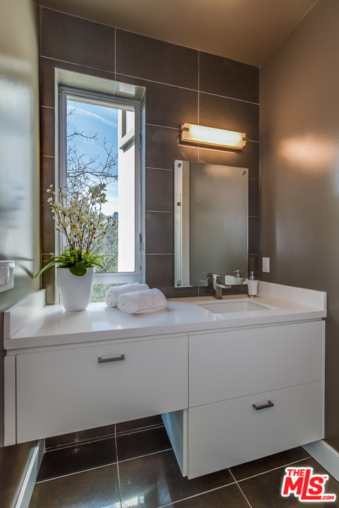3431 Coy Drive Sherman Oaks, CA 91423 - Photo 33 of 54 a bathroom with a sink and a mirror