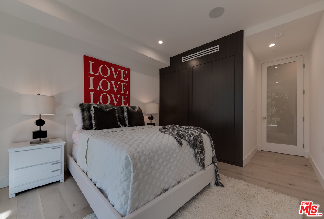 3431 Coy Drive Sherman Oaks, CA 91423 - Photo 41 of 54 a bedroom with a bed and a painting on the wall