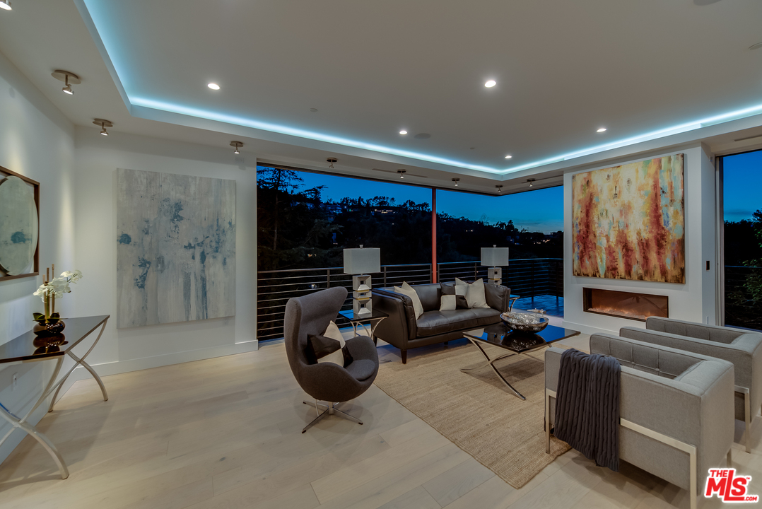 3431 Coy Drive Sherman Oaks, CA 91423 - Photo 50 of 54 a living room with furniture a floor to ceiling window and glass door