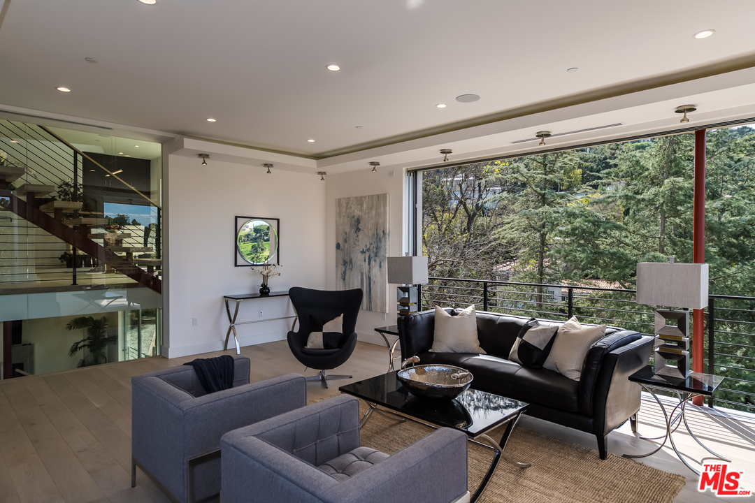 3431 Coy Drive Sherman Oaks, CA 91423 - Photo 7 of 54 a living room with fireplace furniture and a large window