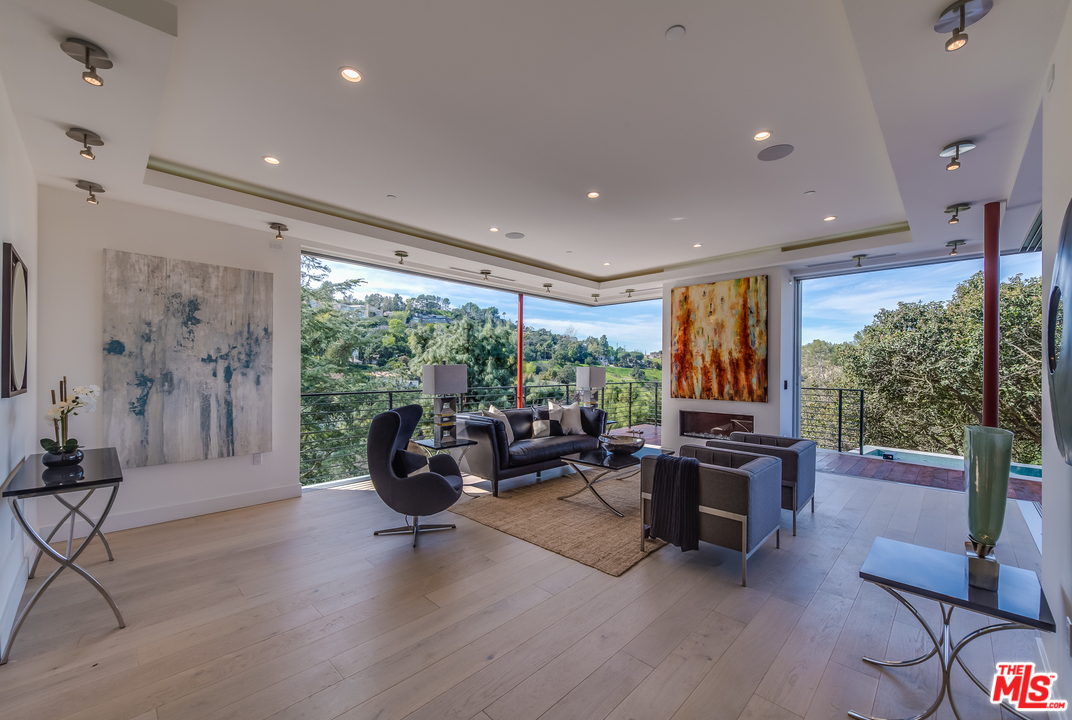 3431 Coy Drive Sherman Oaks, CA 91423 - Photo 9 of 54 a living room with fireplace furniture and a large window