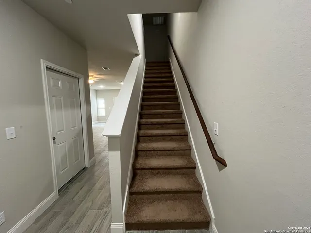 a view of entryway and gallery with wooden floor