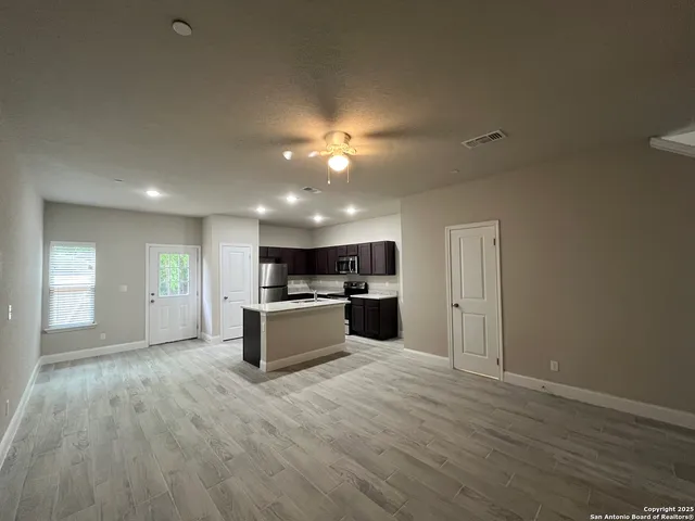 a view of kitchen with sink and wooden floor