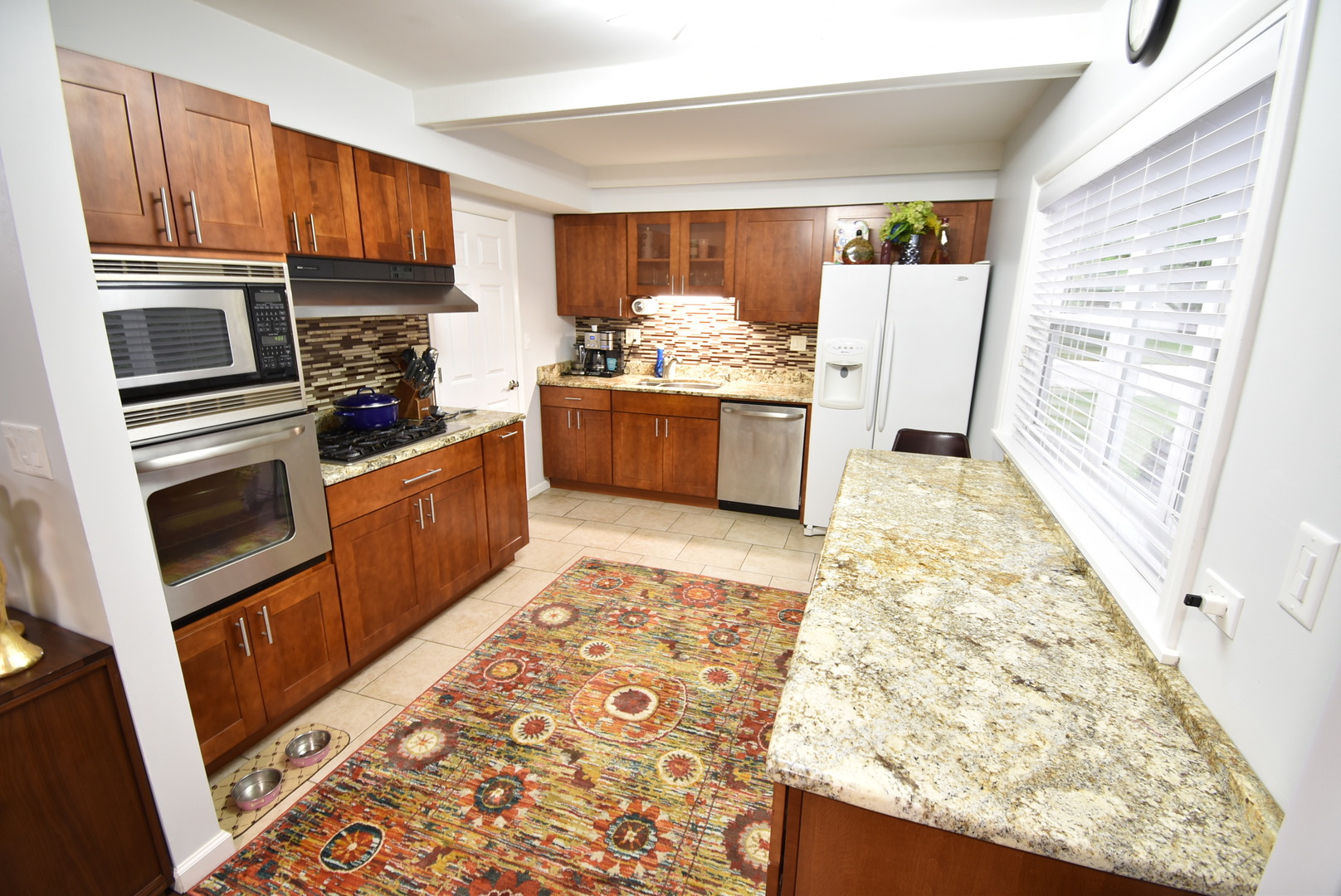 440 Red Bridge Road Lake Zurich, IL 60047 - Photo 5 of 15 a kitchen with granite countertop wooden cabinets and stainless steel appliances