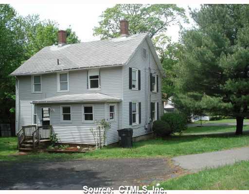 a view of house with a yard