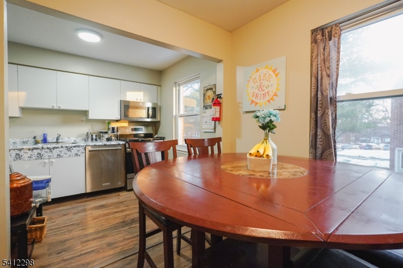 72 Fox Road, Unit 1B Edison, NJ 08817 - Photo 13 of 29 a kitchen with stainless steel appliances granite countertop a stove refrigerator dining table and chairs