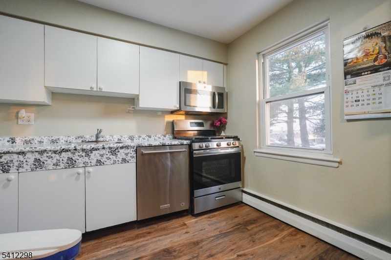 72 Fox Road, Unit 1B Edison, NJ 08817 - Photo 14 of 29 a kitchen with stainless steel appliances granite countertop a stove a sink and a microwave