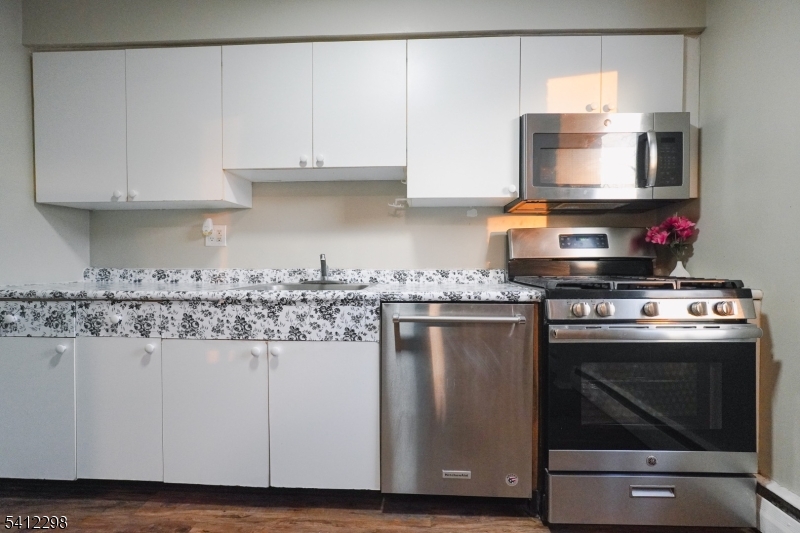 72 Fox Road, Unit 1B Edison, NJ 08817 - Photo 15 of 29 a kitchen with stainless steel appliances granite countertop a stove a sink and a microwave
