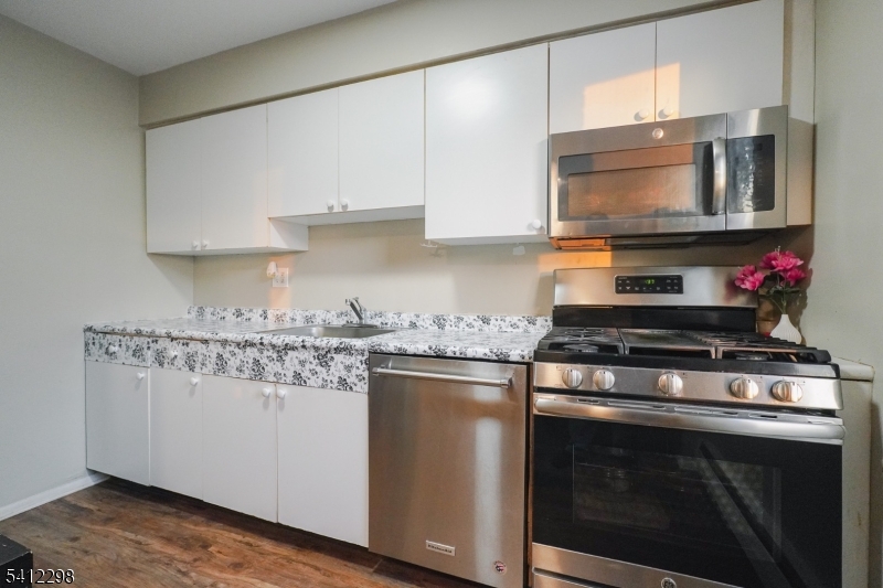 72 Fox Road, Unit 1B Edison, NJ 08817 - Photo 16 of 29 a kitchen with stainless steel appliances granite countertop a stove microwave and sink