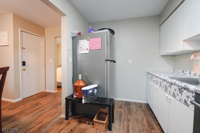 72 Fox Road, Unit 1B Edison, NJ 08817 - Photo 17 of 29 a view of a hallway with wooden floor and a bathroom