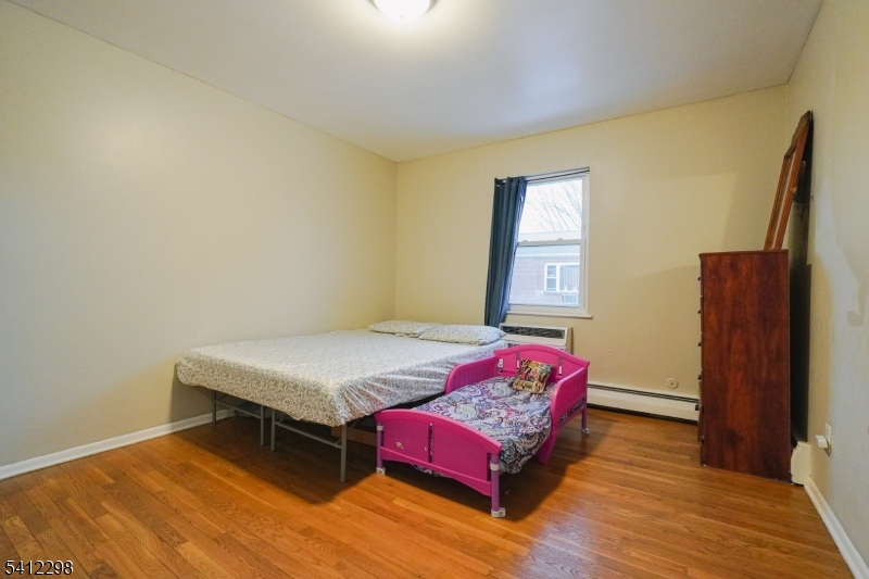 72 Fox Road, Unit 1B Edison, NJ 08817 - Photo 20 of 29 a bedroom with a bed and wooden floor