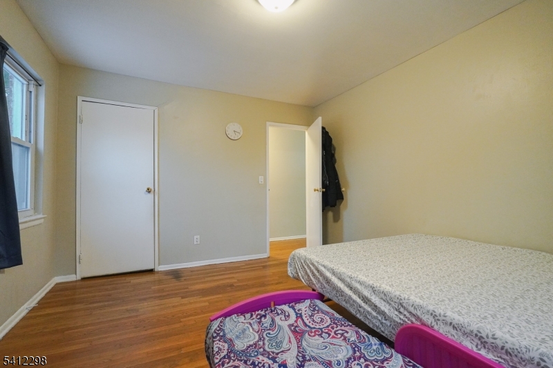 72 Fox Road, Unit 1B Edison, NJ 08817 - Photo 22 of 29 a bedroom with a bed and wooden floor