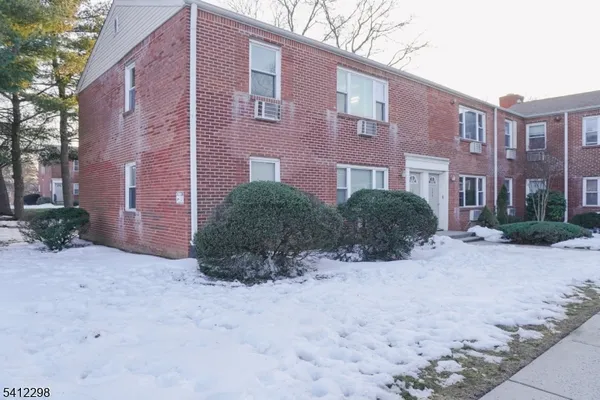 a view of a brick building next to a road