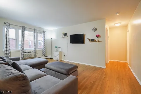 a room with wooden floor and couch