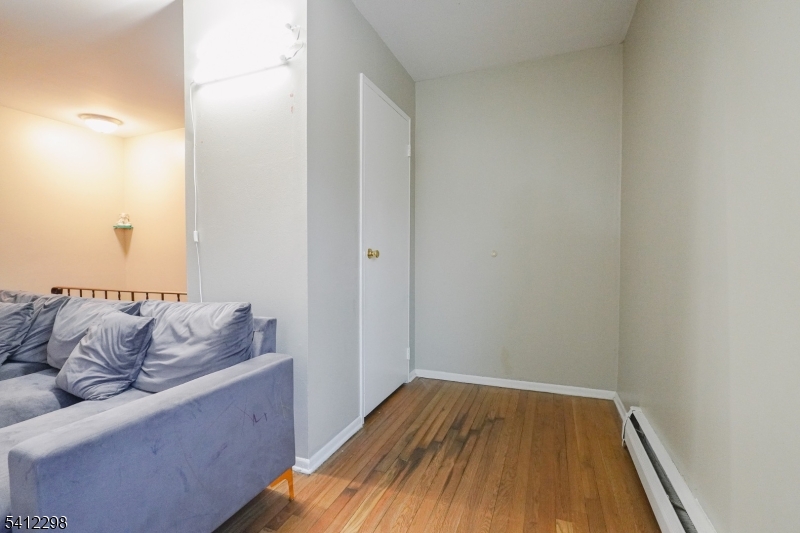 72 Fox Road, Unit 1B Edison, NJ 08817 - Photo 9 of 29 a room with wooden floor and couch