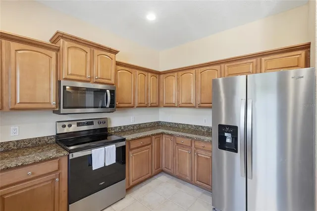 a bathroom with a sink a toilet and a large mirror