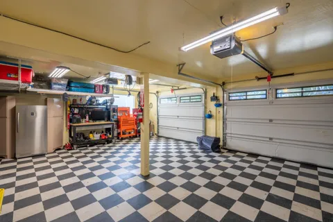 a storage room with a washing machine and storage
