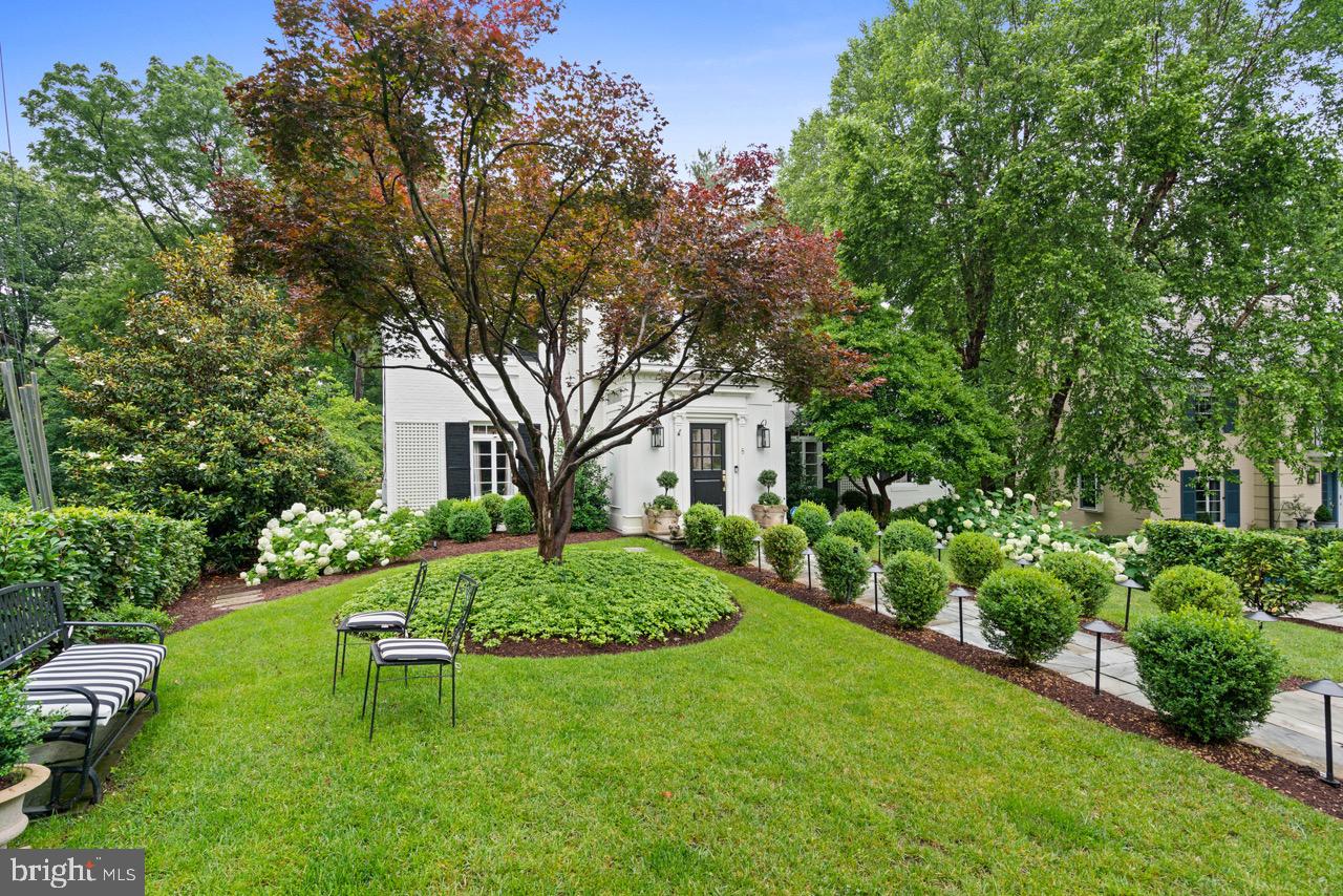 8 Farmington Court Chevy Chase, MD 20815 - Photo 2 of 34 a front view of a house with a yard table and chairs