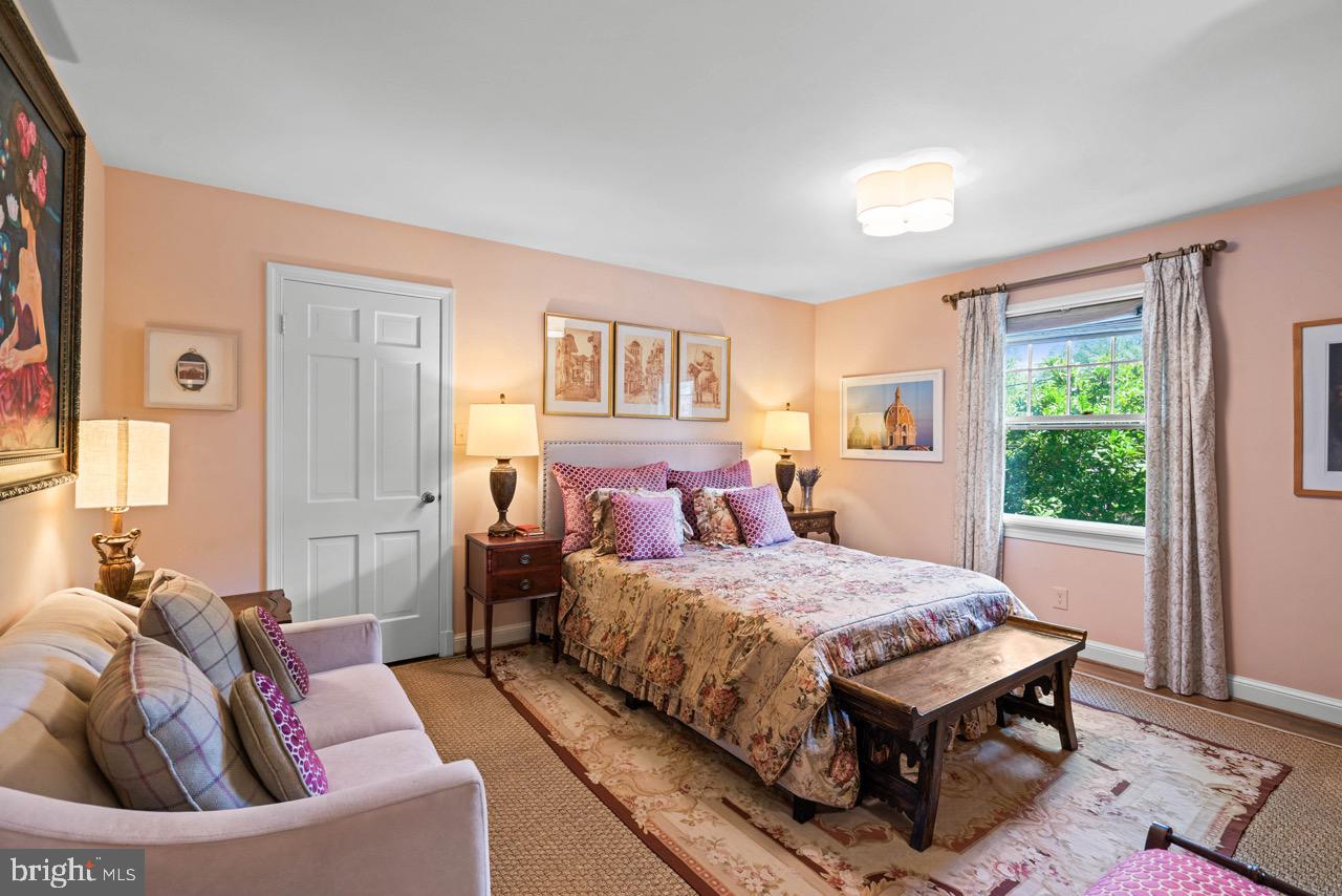 8 Farmington Court Chevy Chase, MD 20815 - Photo 22 of 34 a bedroom with a bed and wooden floor