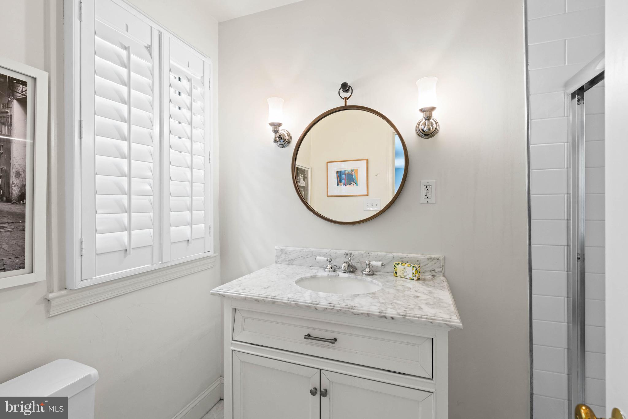 8 Farmington Court Chevy Chase, MD 20815 - Photo 25 of 34 a bathroom with a granite countertop sink a mirror and a shower
