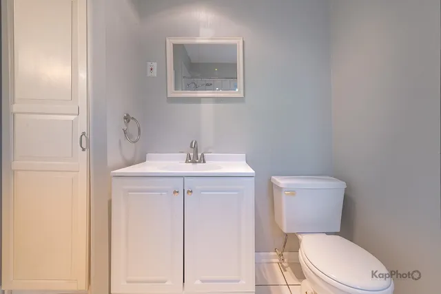 a white toilet sitting next to a bathroom sink