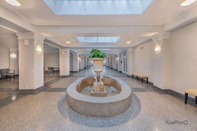 a living room with furniture and a fountain