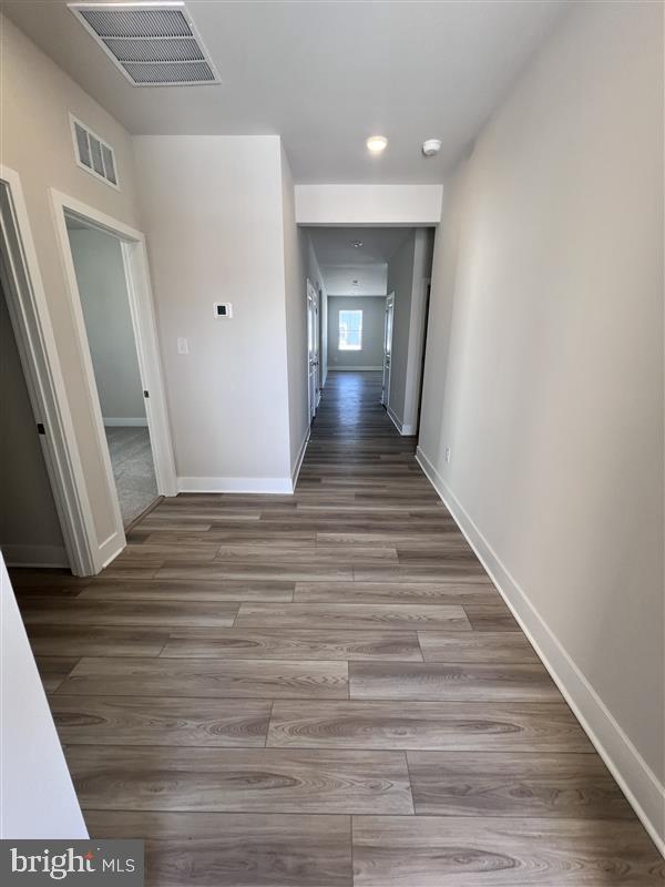 24718 Ridgeville Way Millsboro, DE 19966 - Photo 12 of 16 a view of a hallway view with wooden floor and staircase