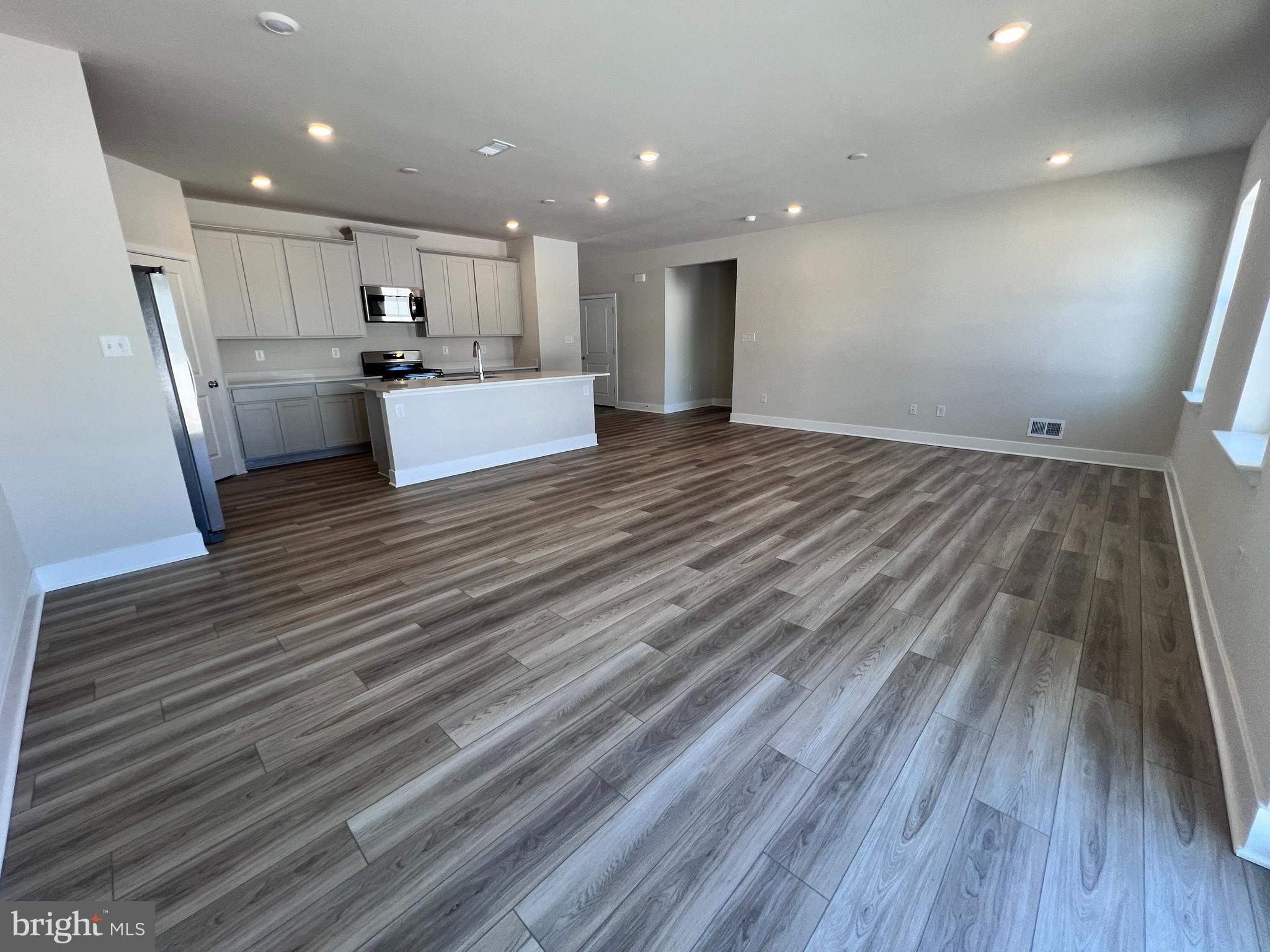 24718 Ridgeville Way Millsboro, DE 19966 - Photo 3 of 16 a view of kitchen and wooden floor