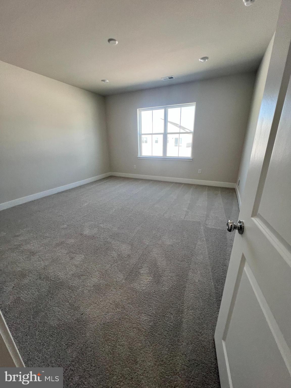 24718 Ridgeville Way Millsboro, DE 19966 - Photo 6 of 16 a view of an empty room with a window