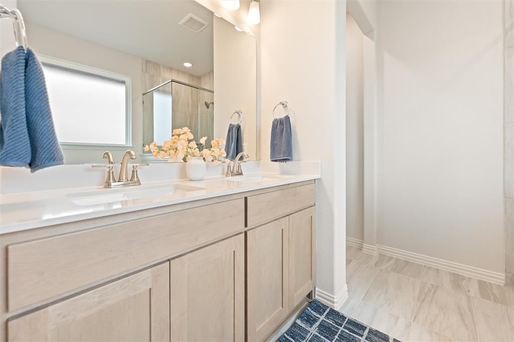 157 Brandywine Trail Rhome, TX 76078 - Photo 24 of 33 Bathroom featuring double vanity and a shower stall