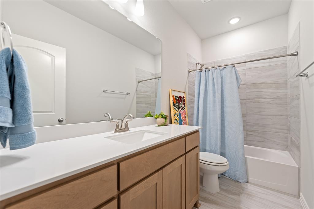 157 Brandywine Trail Rhome, TX 76078 - Photo 27 of 33 Full bathroom featuring vanity and shower / tub combo with curtain