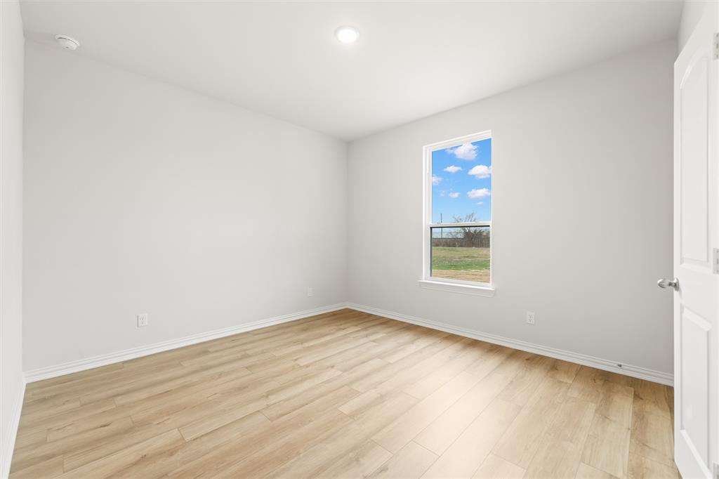 157 Brandywine Trail Rhome, TX 76078 - Photo 28 of 33 Spare room featuring light wood-style floors and recessed lighting