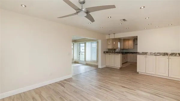 a view of a kitchen with a sink and cabinets
