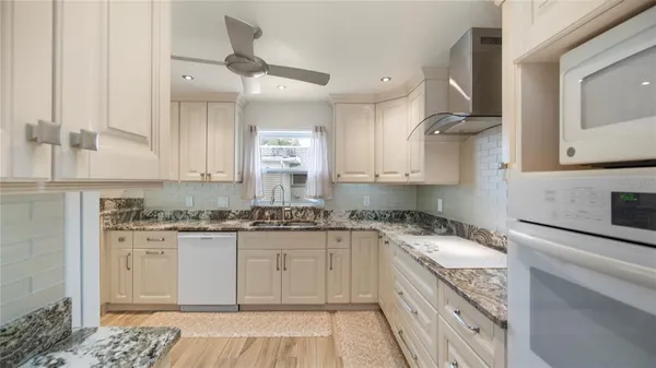 a kitchen with a sink stove and cabinets
