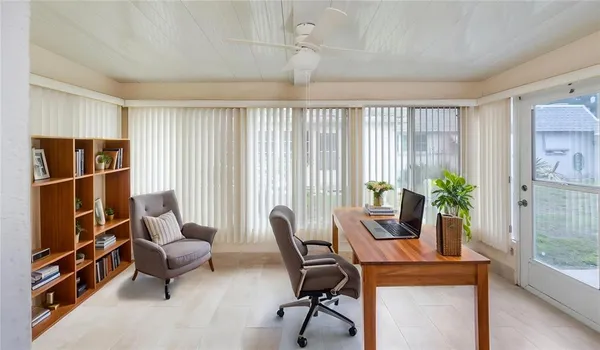 a living room with furniture and a potted plant