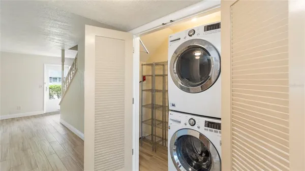 a view of a hallway with washer and dryer