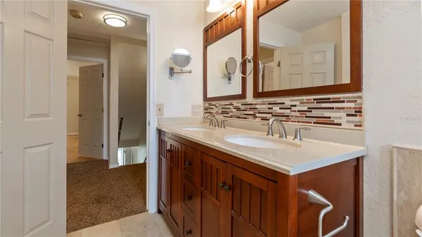 a bathroom with a sink vanity and a mirror