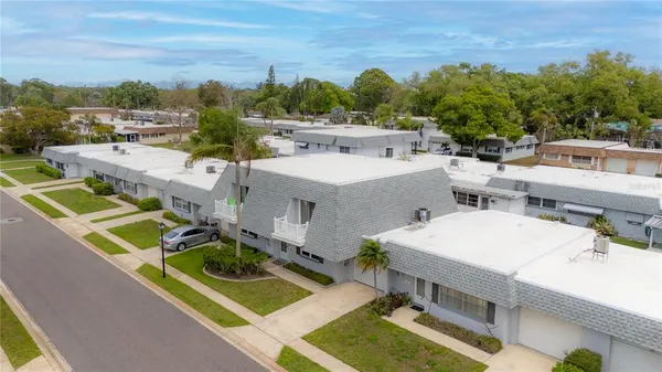 a view of a house with pool and chairs