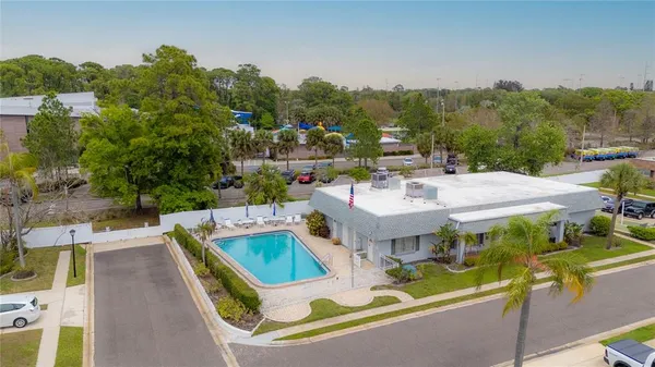 a view of a house with pool and chairs