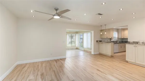 a view of kitchen with granite countertop cabinets and refrigerator