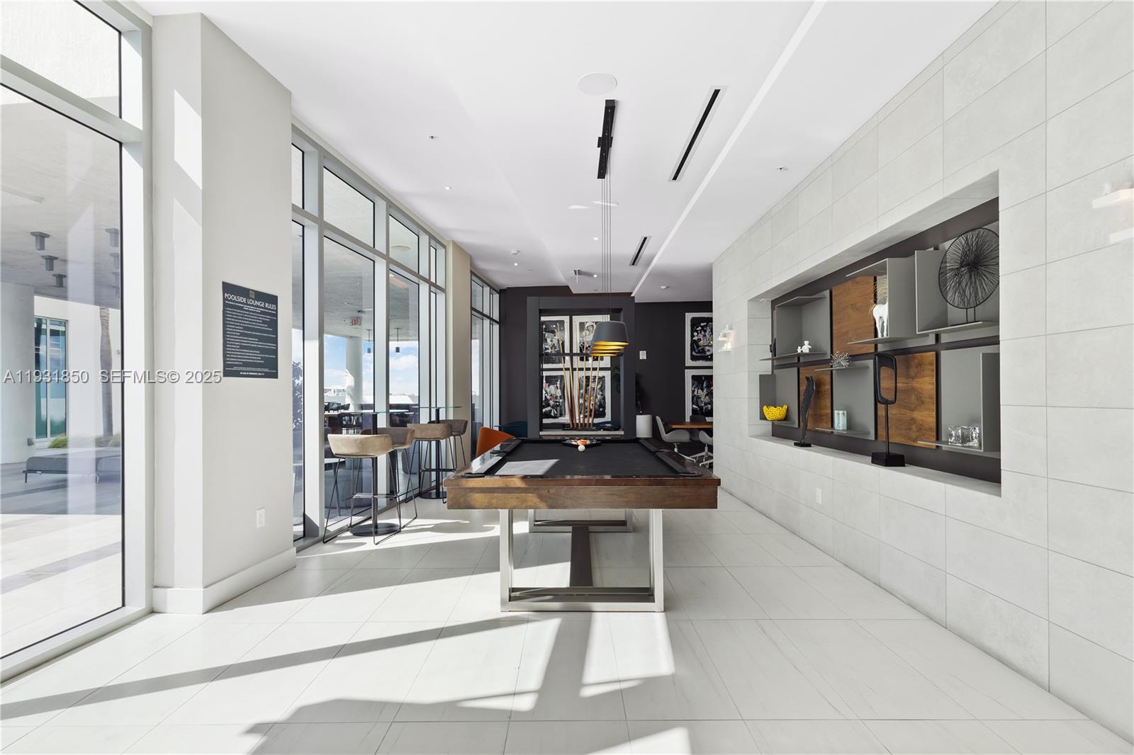 3900 Biscayne Boulevard, Unit S802 Miami, FL 33137 - Photo 23 of 29 a room with lots of glass windows and furniture