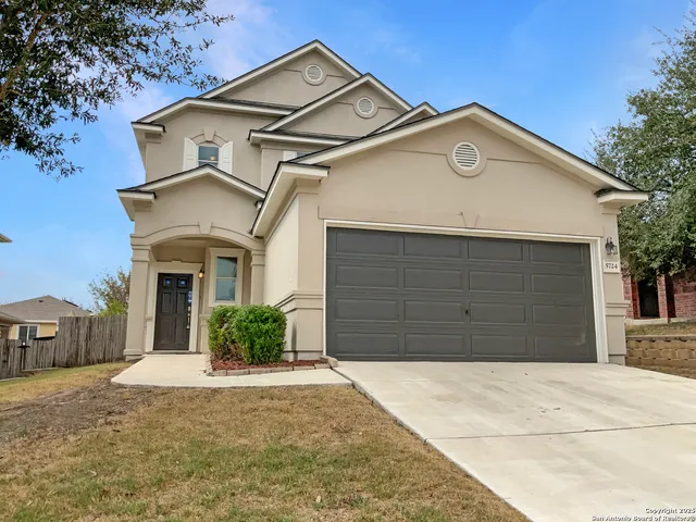 a front view of a house with a yard and garage