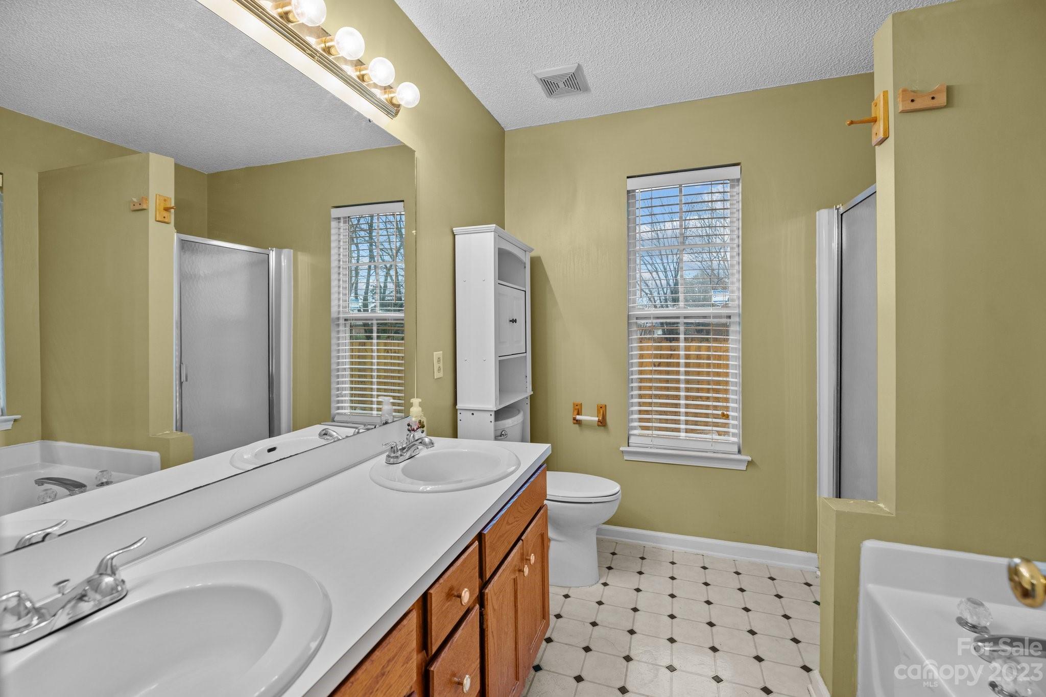 4445 Fawnbrook Avenue Southwest Concord, NC 28027 - Photo 14 of 27 a bathroom with a double vanity sink mirror and double