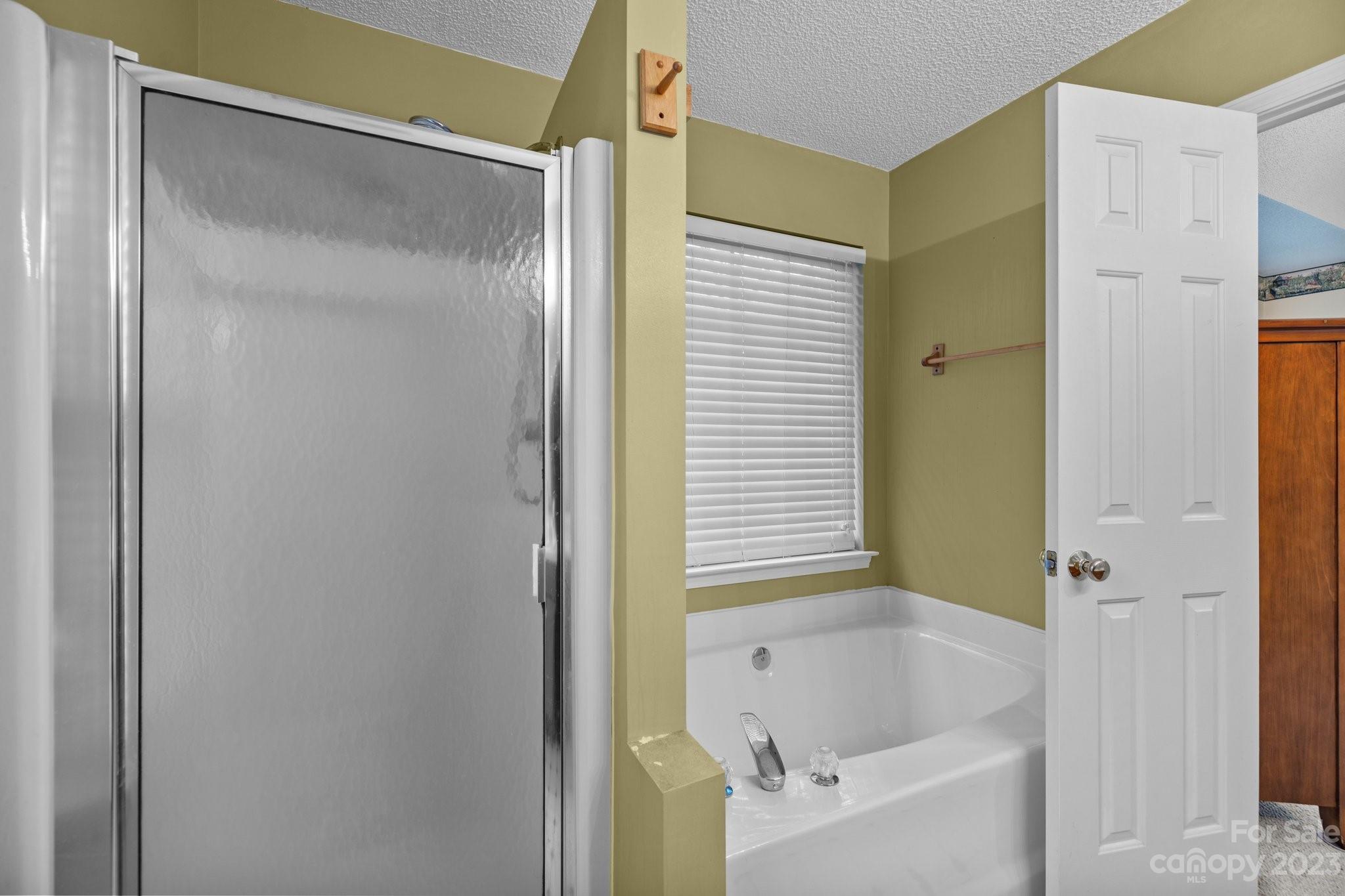 4445 Fawnbrook Avenue Southwest Concord, NC 28027 - Photo 15 of 27 a bathroom with a bathtub and a shower