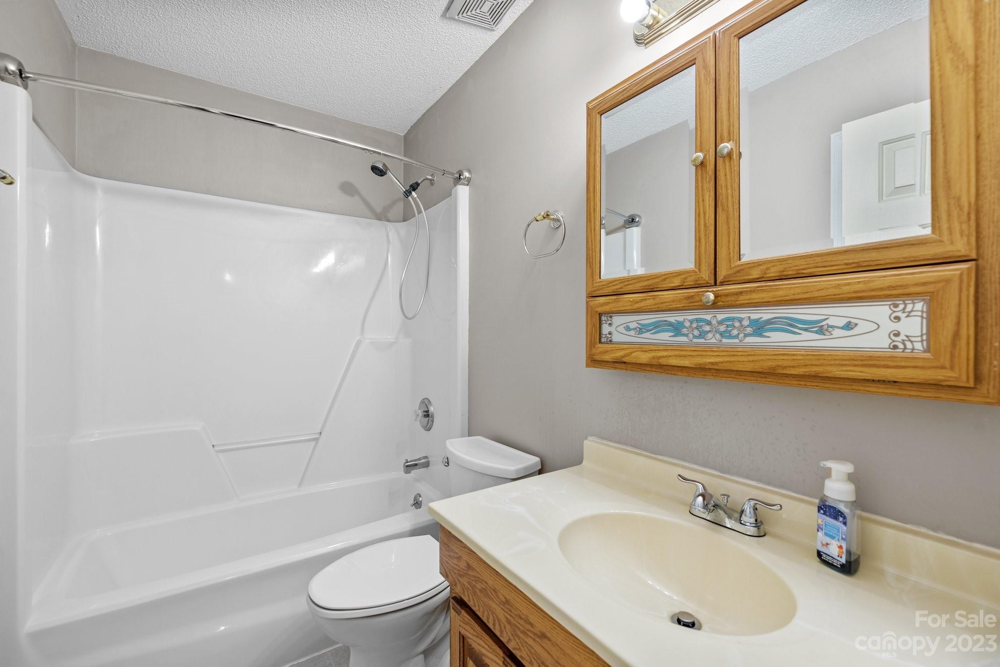 4445 Fawnbrook Avenue Southwest Concord, NC 28027 - Photo 17 of 27 a bathroom with a sink a toilet and a bathtub